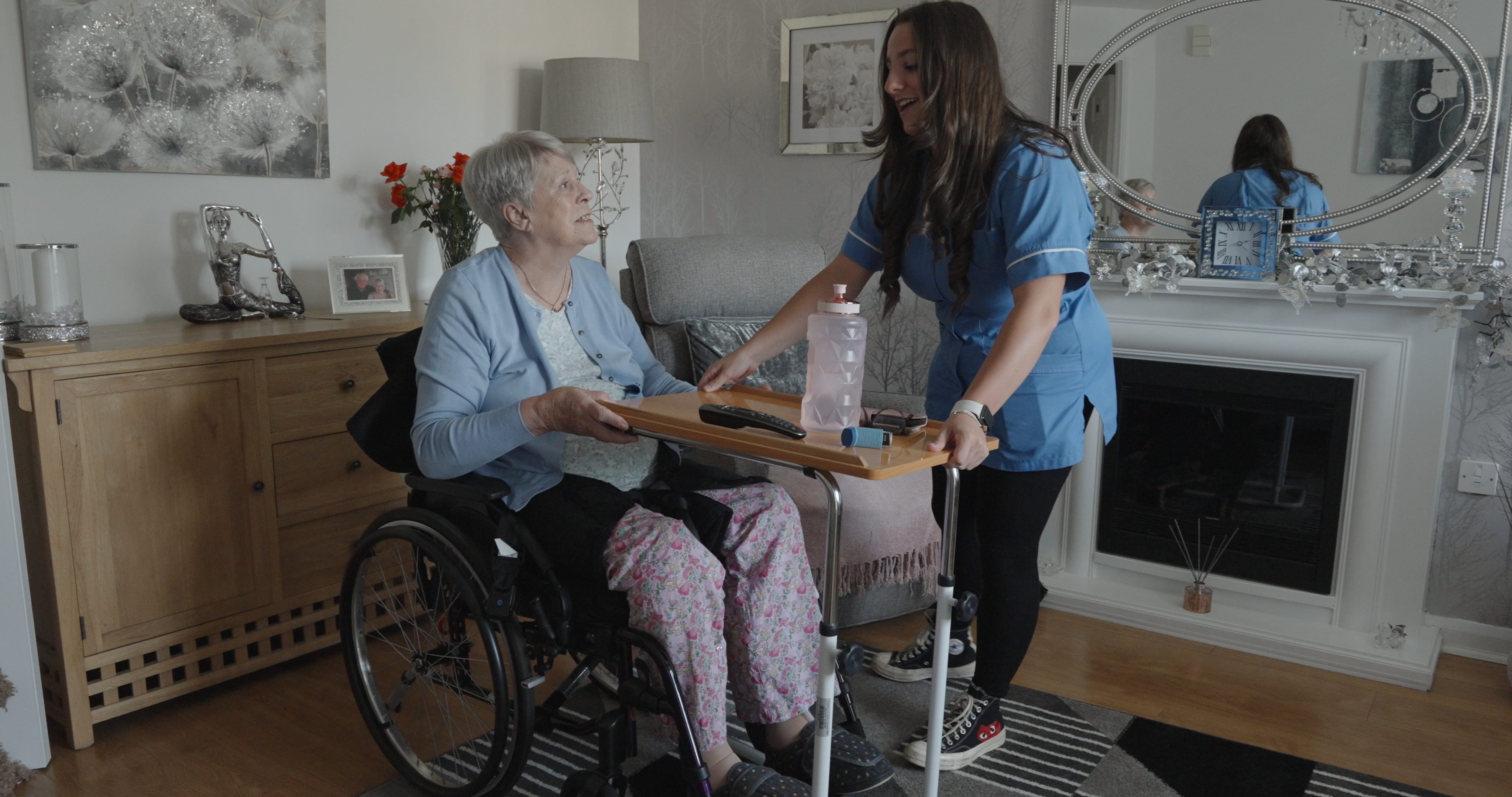 A photo of a domiciliary care assistant supporting a lady.