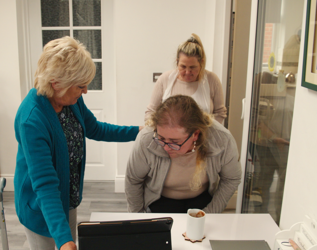 A photo of two personal assistants supporting a young woman.