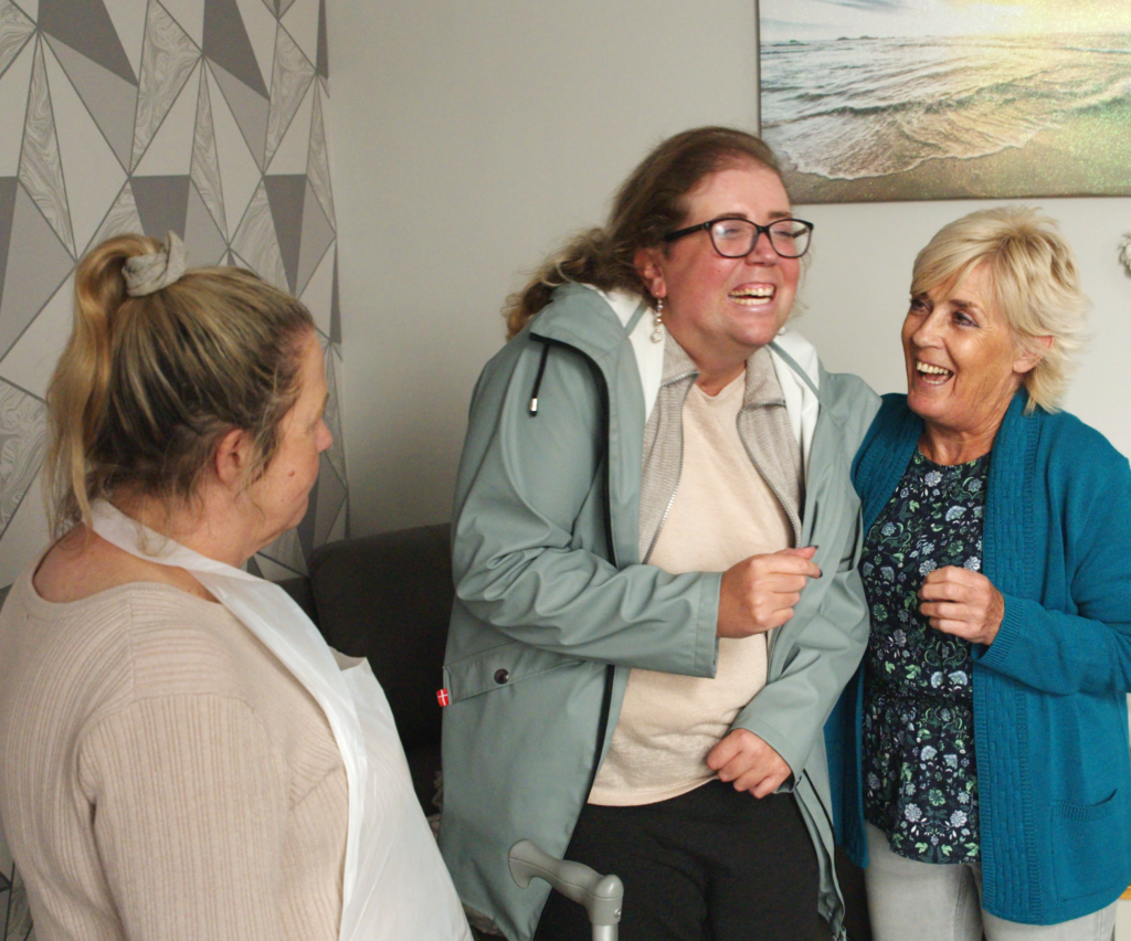 A photo of a young woman supported by her two carers. south tyneside care academy