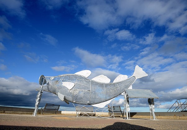 Metal fish on beach to put litter in